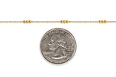 Gold-filled chain with a quarter dollar coin on a white background